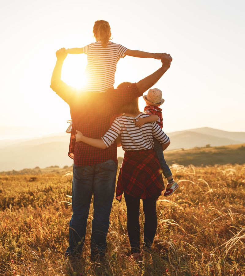 family walking in a sunny field